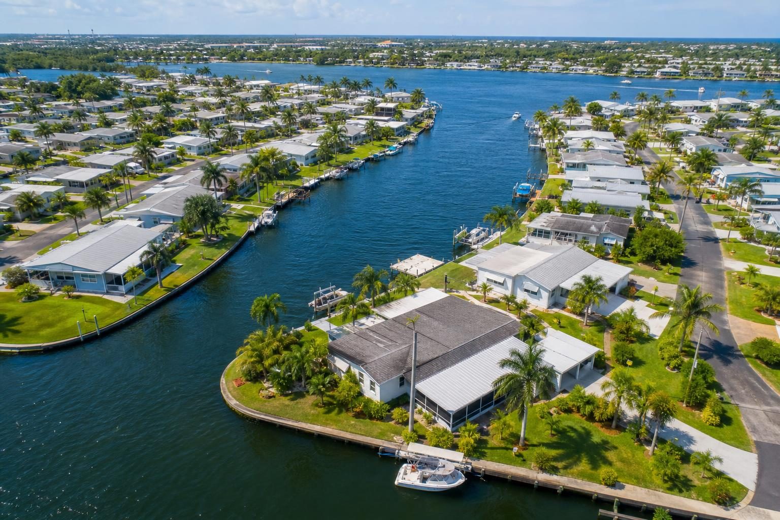 Aerial view of the waterfront community with canals, docks, and homes